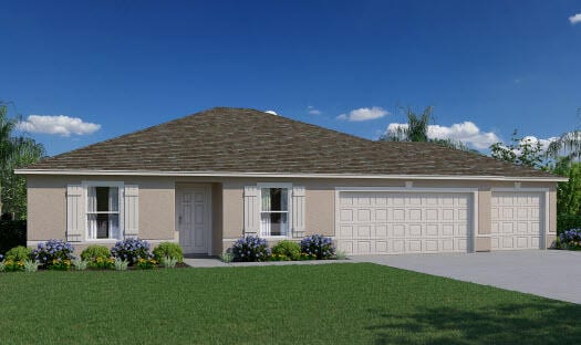 view of front of home featuring a front yard and a garage