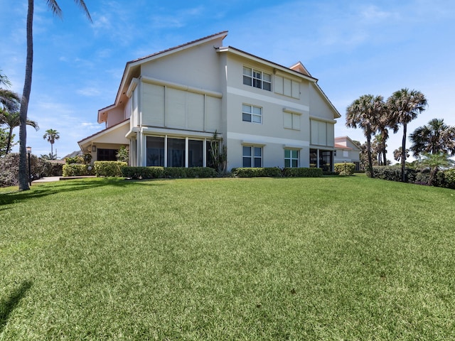 rear view of property featuring a yard