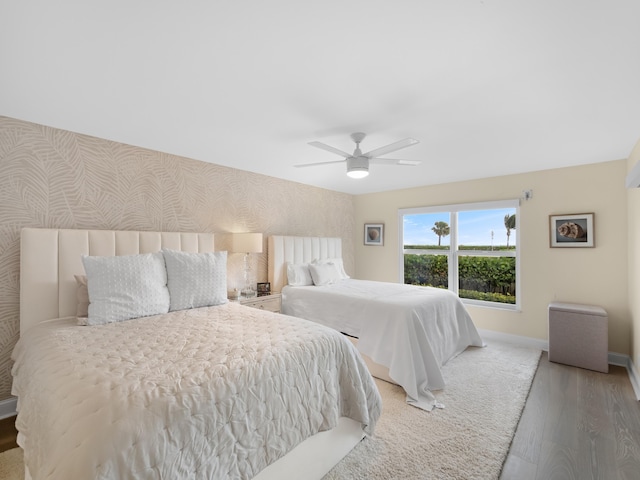 bedroom with ceiling fan and wood-type flooring