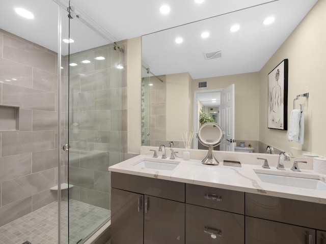 bathroom featuring vanity and an enclosed shower