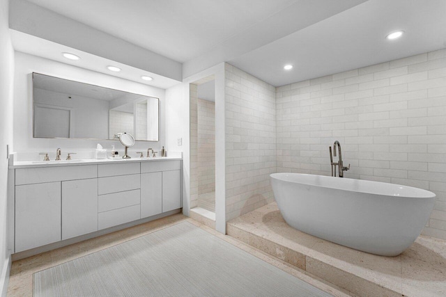 bathroom with vanity, tile walls, and separate shower and tub