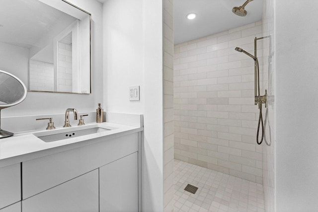 bathroom featuring vanity and tiled shower