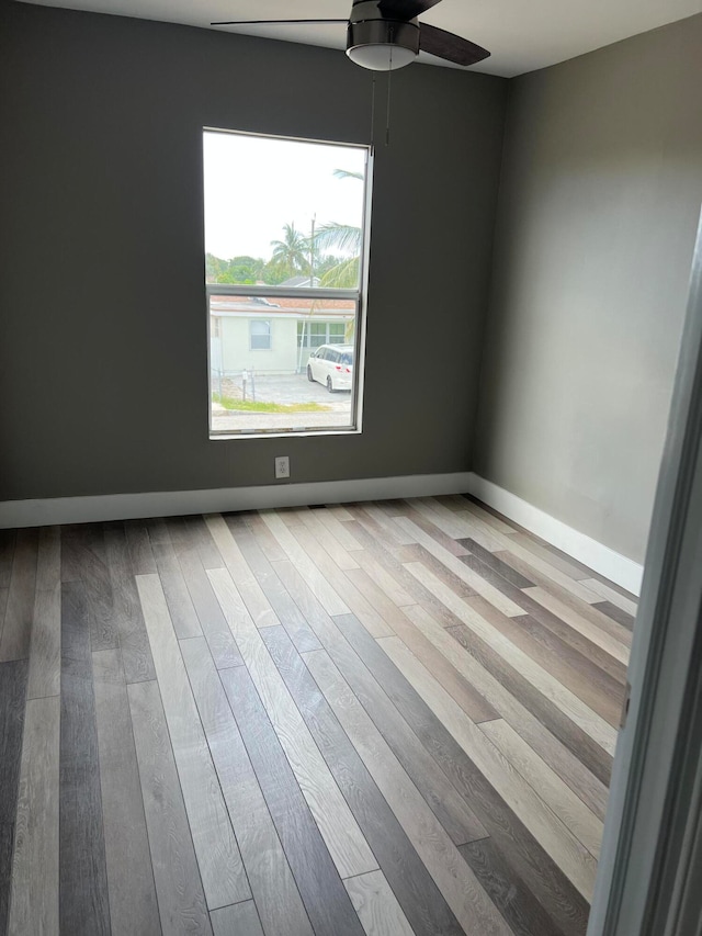 empty room featuring light wood-type flooring and ceiling fan