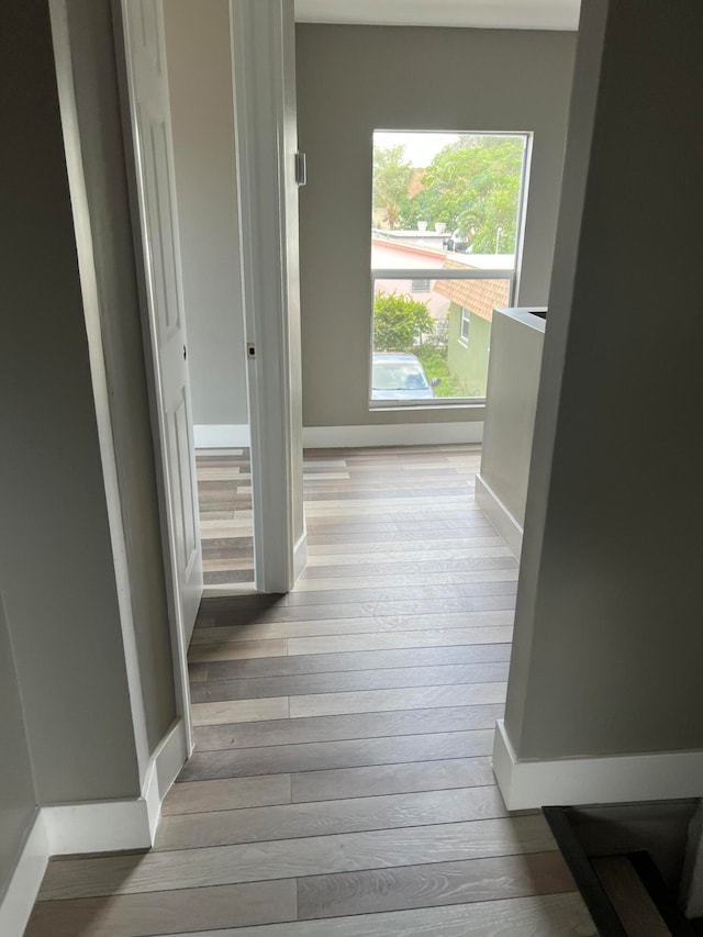 hallway with light hardwood / wood-style flooring