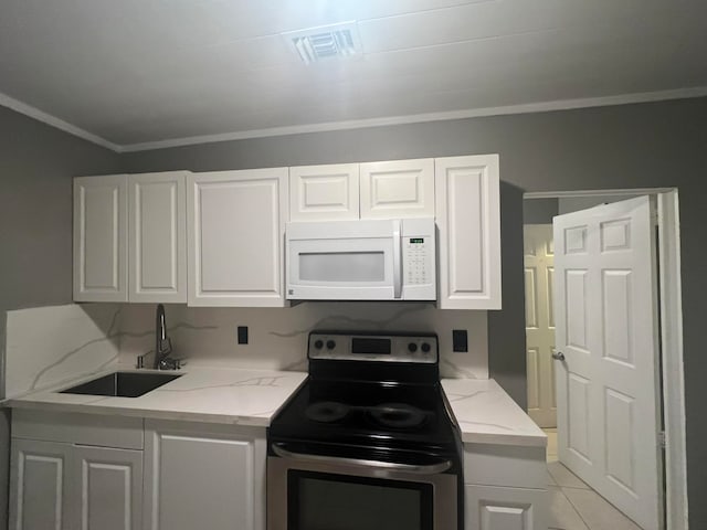 kitchen with white cabinets, light tile patterned floors, ornamental molding, sink, and electric range