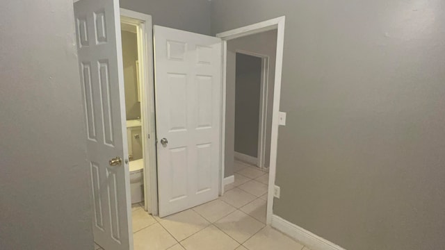 hallway featuring light tile patterned floors