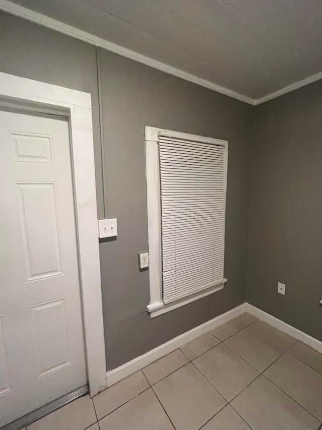 interior space featuring tile patterned flooring and ornamental molding