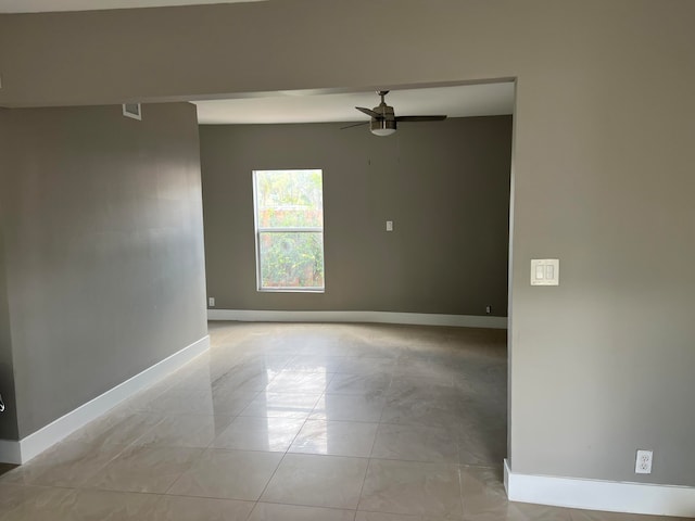 unfurnished room featuring light tile patterned flooring and ceiling fan