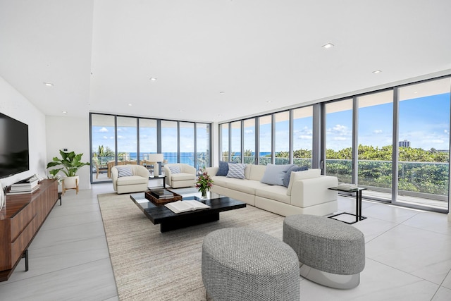 living room with floor to ceiling windows and light tile patterned flooring