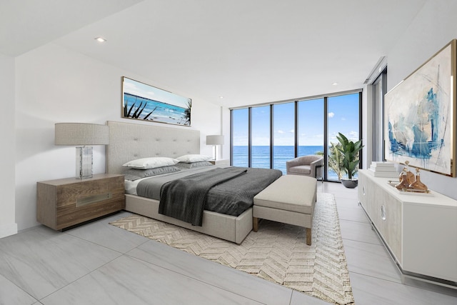 bedroom with access to outside, expansive windows, a water view, and light tile patterned floors