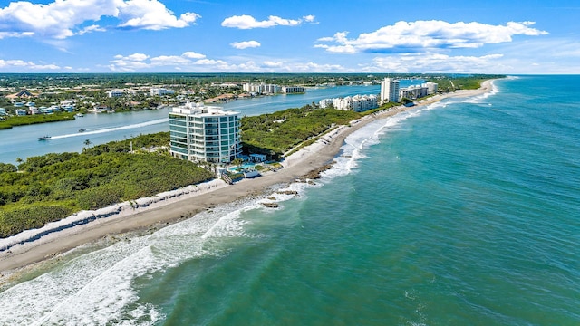 bird's eye view with a water view and a beach view