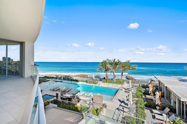 view of pool featuring a view of the beach and a water view