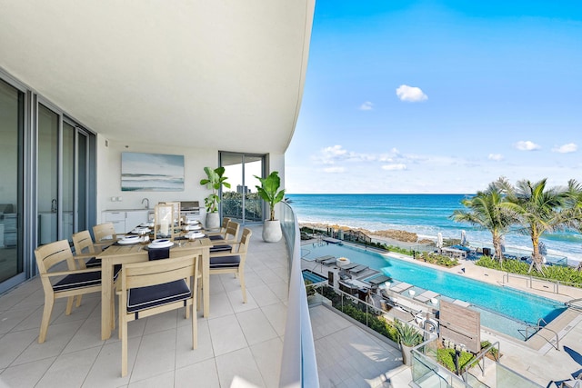 balcony with a beach view and a water view