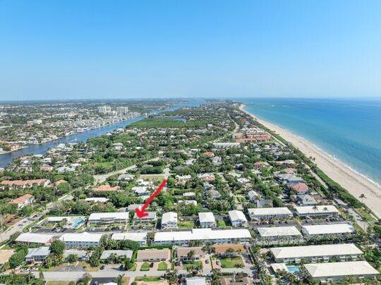 birds eye view of property with a view of the beach and a water view