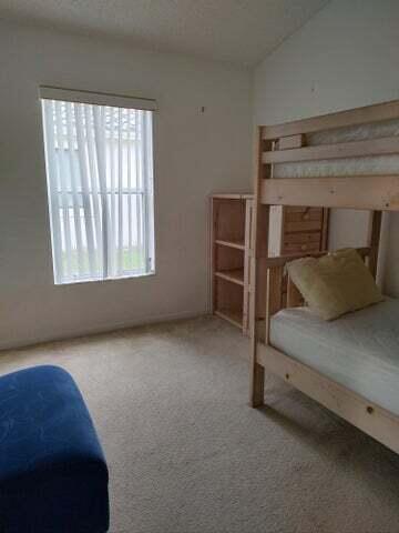 unfurnished bedroom with carpet and vaulted ceiling