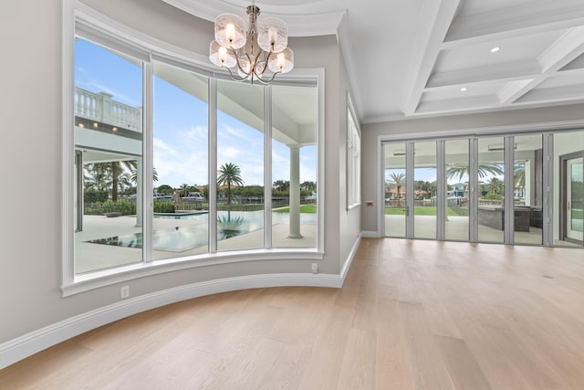 spare room featuring a notable chandelier, beamed ceiling, crown molding, coffered ceiling, and light wood-type flooring