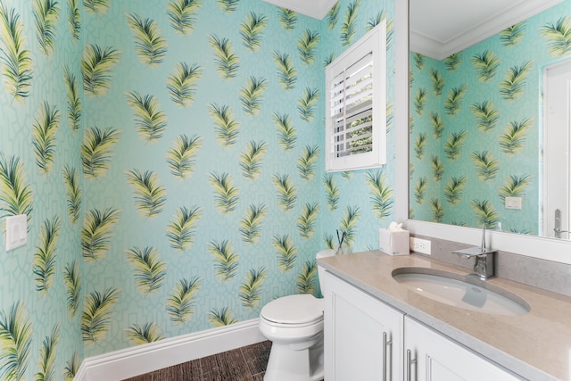 bathroom with wood-type flooring, toilet, vanity, and crown molding