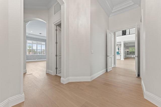 hallway featuring light wood-type flooring and crown molding