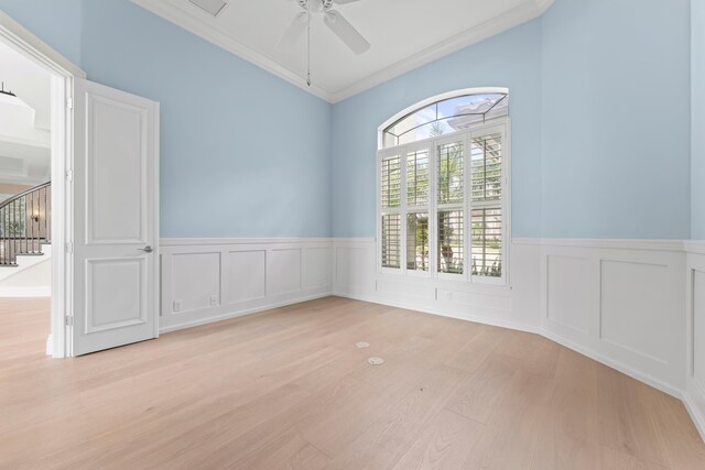 empty room featuring ceiling fan, light wood-type flooring, and ornamental molding