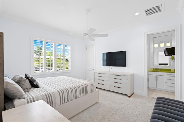 bedroom with ceiling fan, crown molding, connected bathroom, and sink