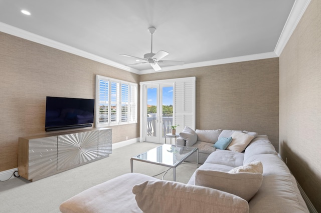 carpeted living room with ceiling fan and ornamental molding