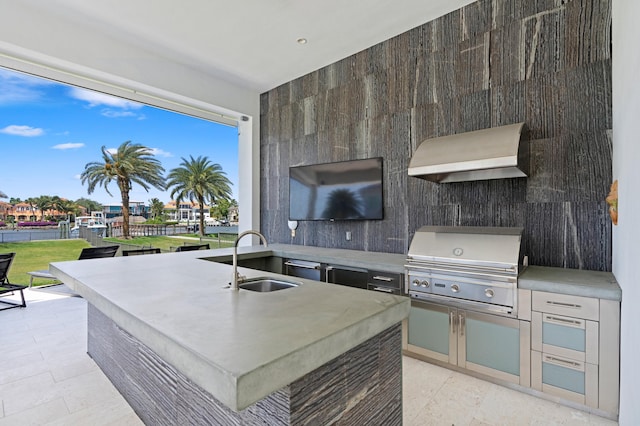 view of patio featuring exterior kitchen, sink, and a grill