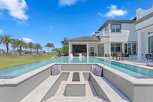 view of swimming pool featuring a patio area and a fire pit