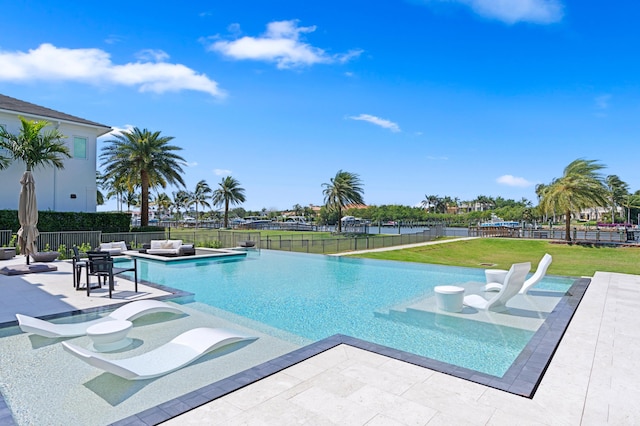 view of swimming pool featuring a patio area and a yard