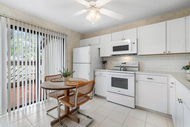 kitchen featuring white appliances, white cabinetry, light tile patterned floors, and ceiling fan