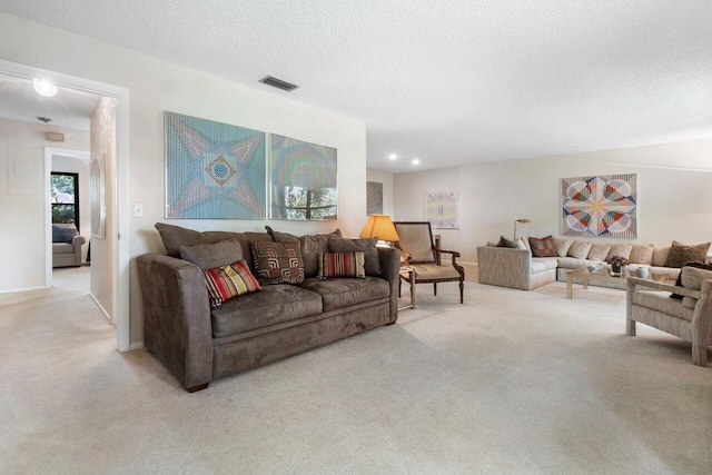 carpeted living room featuring a textured ceiling