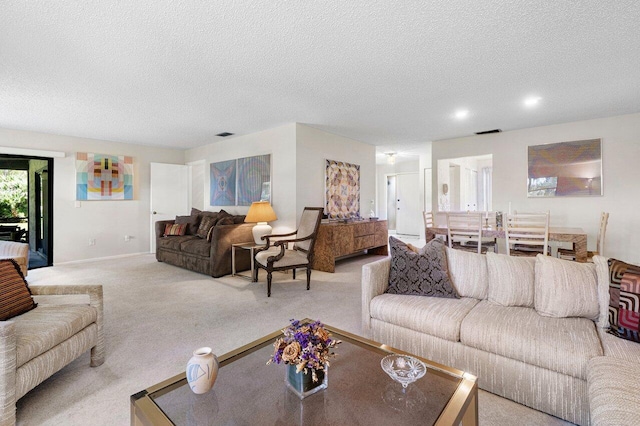 living room with light colored carpet and a textured ceiling