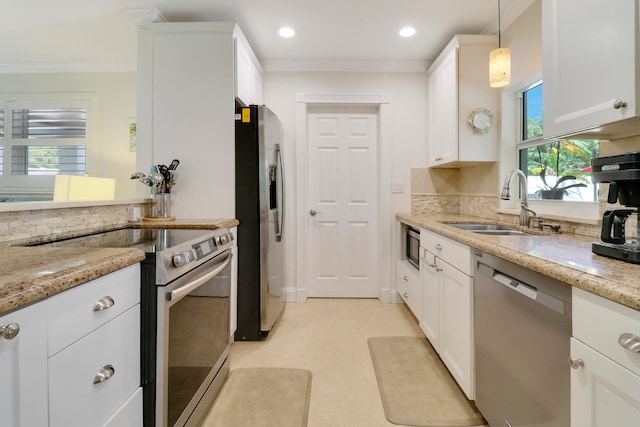 kitchen with pendant lighting, plenty of natural light, decorative backsplash, and appliances with stainless steel finishes