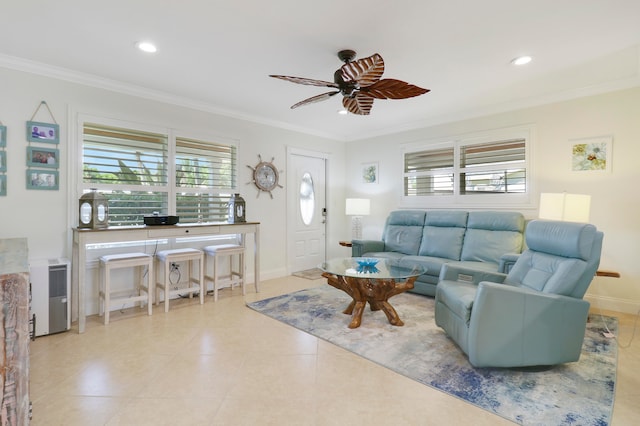 tiled living room with ceiling fan, ornamental molding, and a wealth of natural light