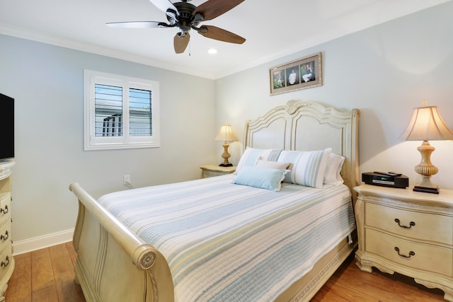 bedroom with ceiling fan, light hardwood / wood-style flooring, and crown molding