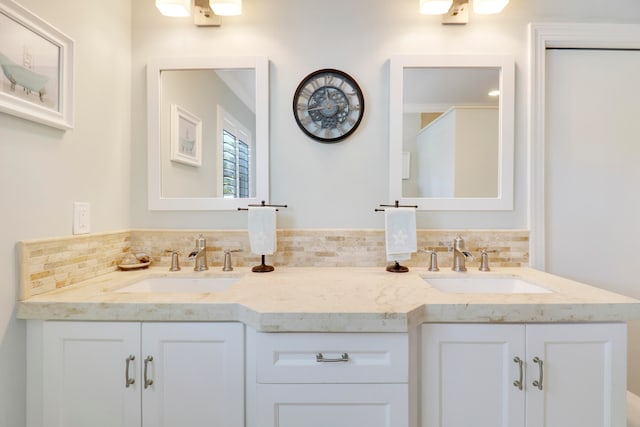 bathroom with vanity and tasteful backsplash