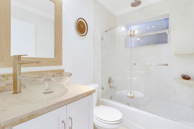 full bathroom featuring vanity, ornamental molding, toilet, and combined bath / shower with glass door