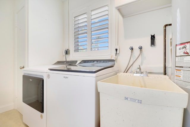 laundry area with washing machine and dryer and sink