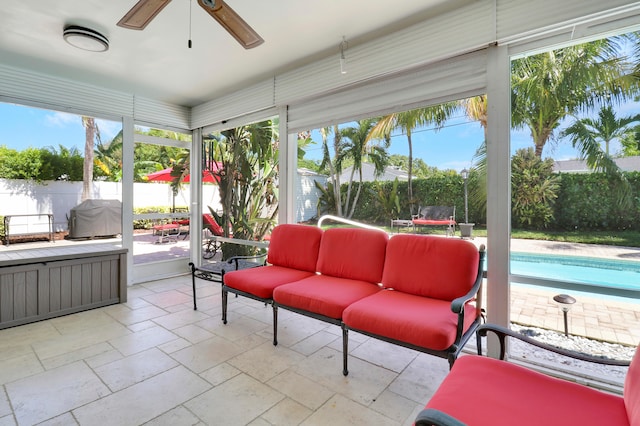 sunroom / solarium featuring ceiling fan and a wealth of natural light