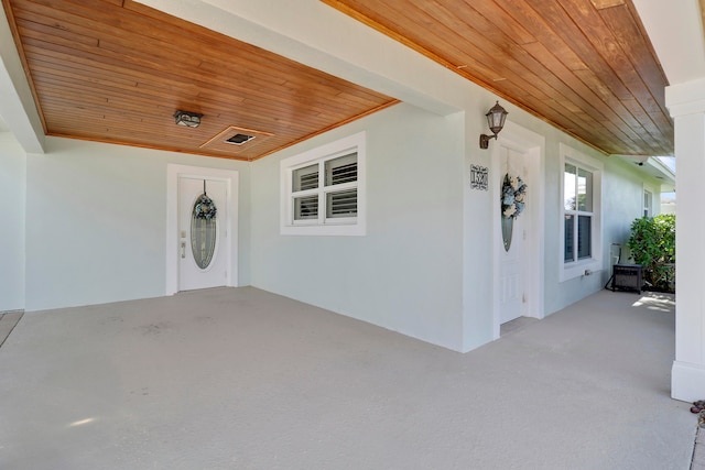 view of exterior entry featuring covered porch