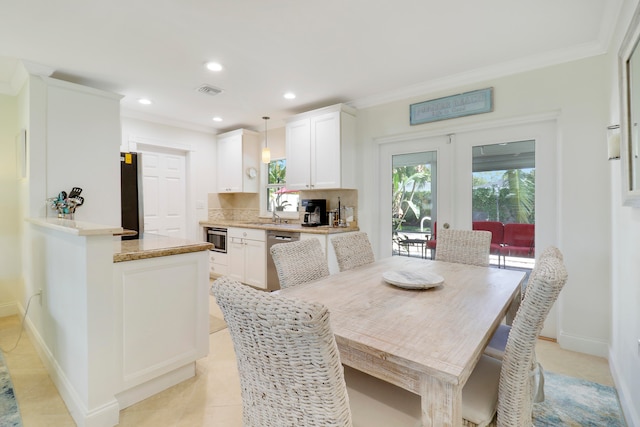 tiled dining space with french doors, sink, and ornamental molding