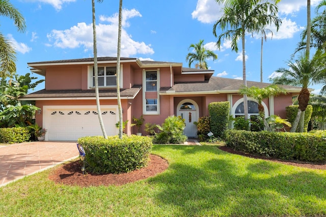 view of front of house with a garage and a front yard