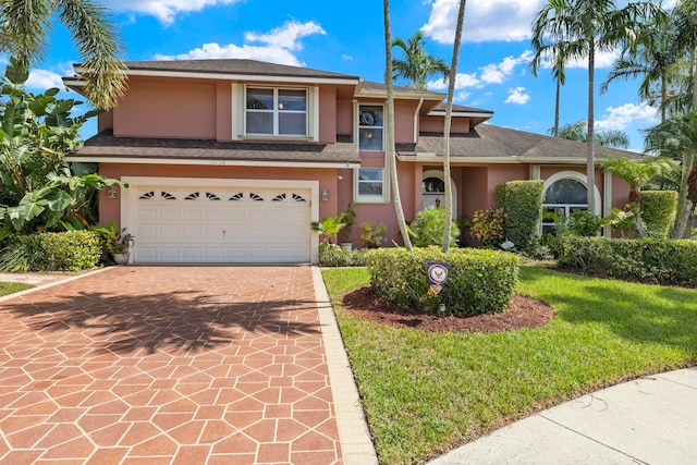 view of front of property featuring a garage and a front yard