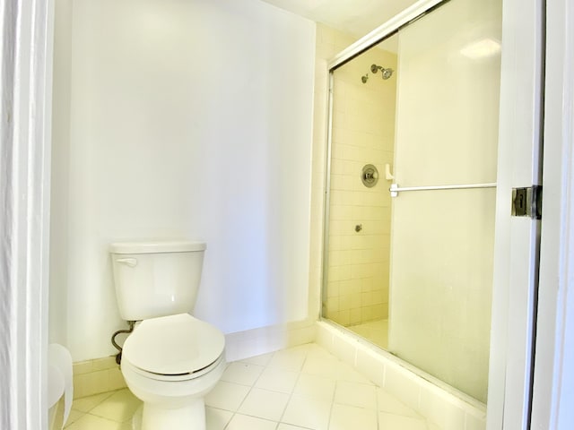 bathroom with walk in shower, tile patterned flooring, and toilet