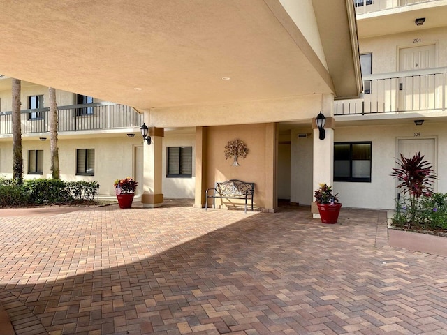 property entrance with a patio and a balcony