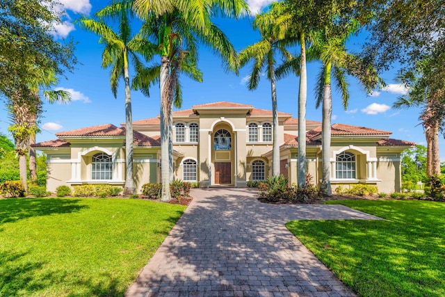 mediterranean / spanish house featuring a front lawn