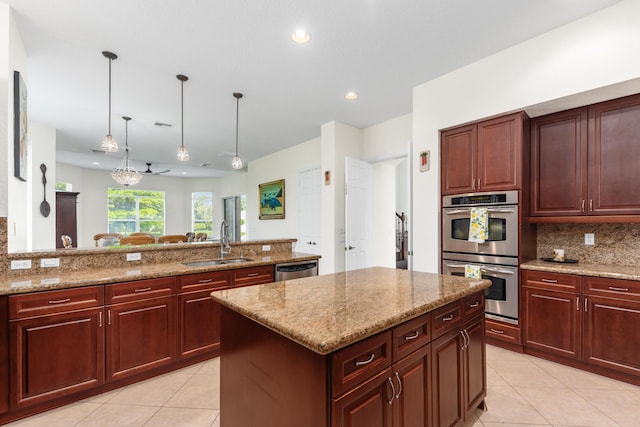 kitchen with backsplash, stainless steel appliances, light tile patterned floors, and a sink