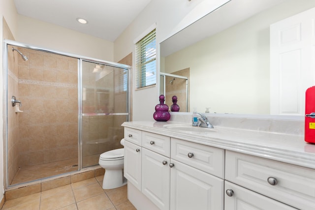 bathroom with vanity, toilet, tile patterned flooring, and a stall shower