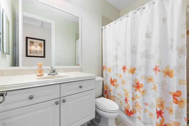 bathroom with toilet, tile patterned floors, shower / bath combination with curtain, and vanity