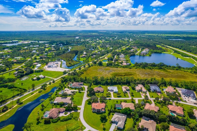 drone / aerial view with a residential view and a water view
