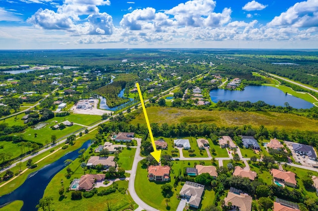 drone / aerial view with a water view and a residential view